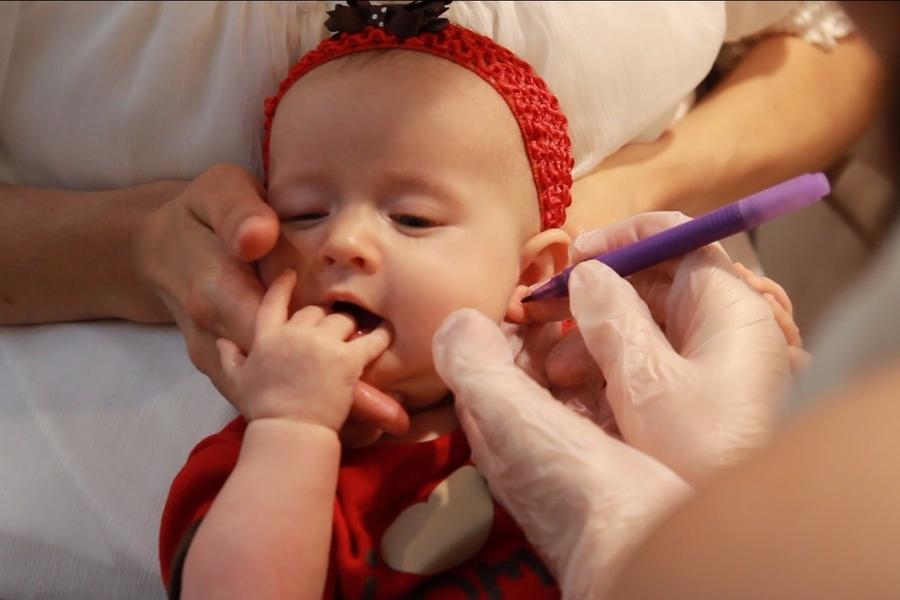 How should you go about piercing your child’s ear?
